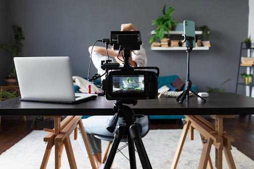 Video cover letter tips setup with camera, laptop, and smartphone tripod for creative professionals in visual storytelling jobs